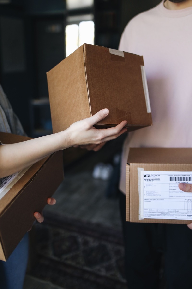 Courier receiving a parcel during collection.